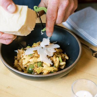 Hands preparing a meal.