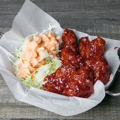 Sweet, sour, and spicy Korean fried chicken wings with shredded lettuce.