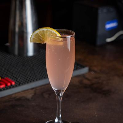 Rockey'ss Ruby Royal cocktail served on a bar counter.