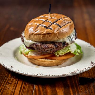 Cheeseburger with lettuce, tomato, and onions.