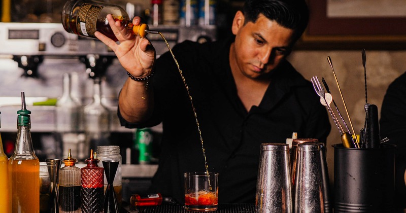A bartender making a drink
