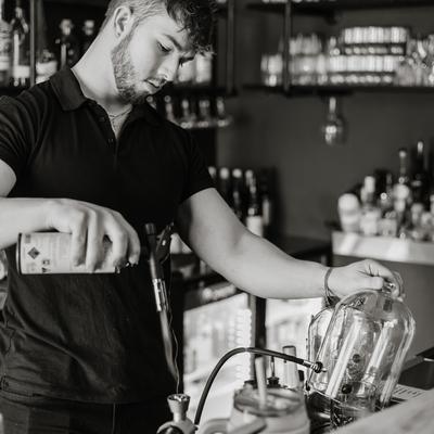 Bartender smoking a cocktail.