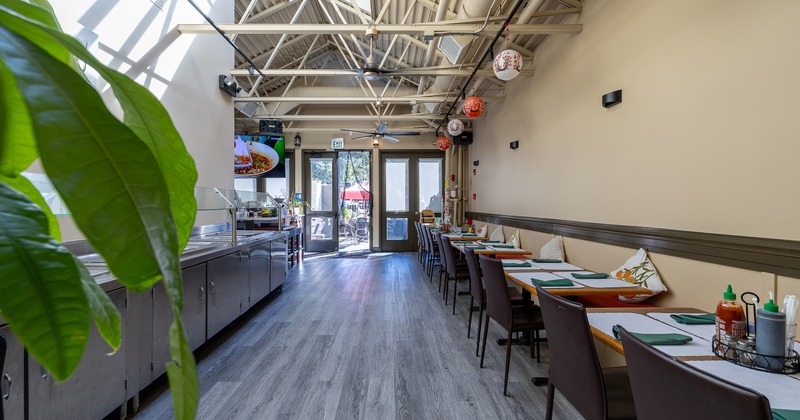 Spacious interior dining area with dining tables along the wall