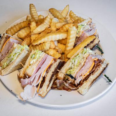 Classic club sandwiches with fries.