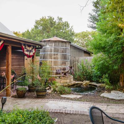 Patio, plants, pond with fountain, peaceful ambiance
