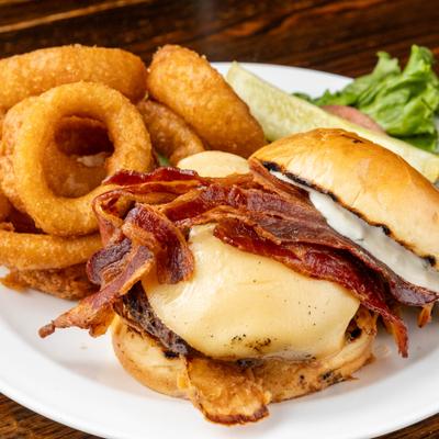 Gouda and bacon burger with side onion rings.