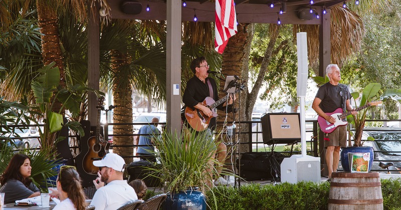Outdoor seating area, a band playing music on the stage