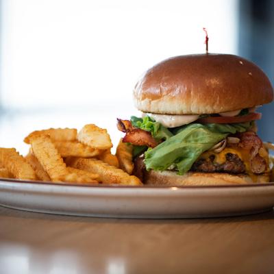 The O G Legendary Burger served with a side of fries.