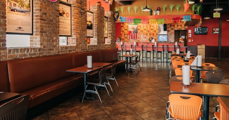 Interior, dining tables and seating, bar in the back