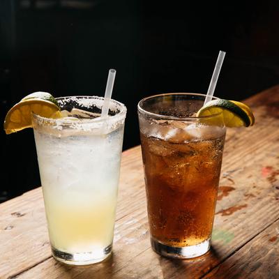 Two cocktails with lime on glass