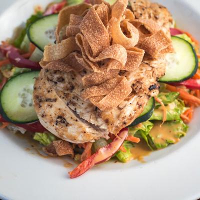 Salad, grilled sliced meat and pasta
