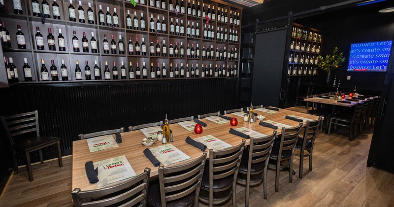 Interior - wine bottles on shelves, wooden tables, chairs and decorative elements