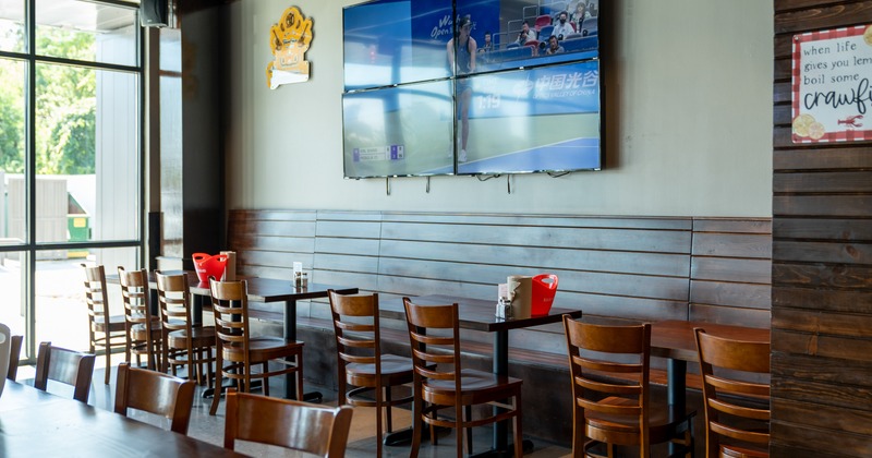 Diner area, tables and chairs, tv above