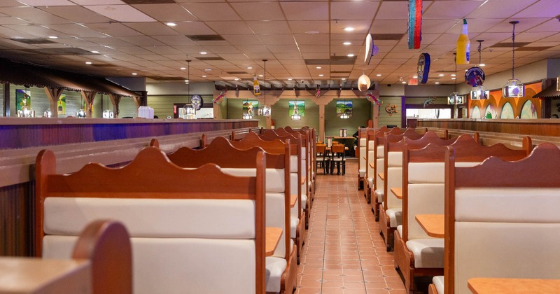 Interior, separate dining area, padded seating booths with tables