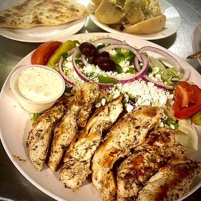 Chicken Souvlaki, served with Greek salad, grilled pita bread, and dipping sauce.