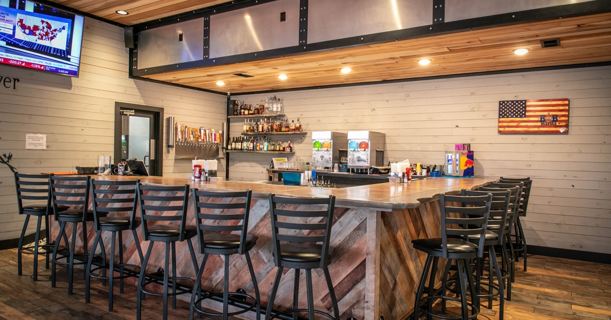 Interior, wooden top bar with stools, drink shelves, drink fountains, wooden flooring