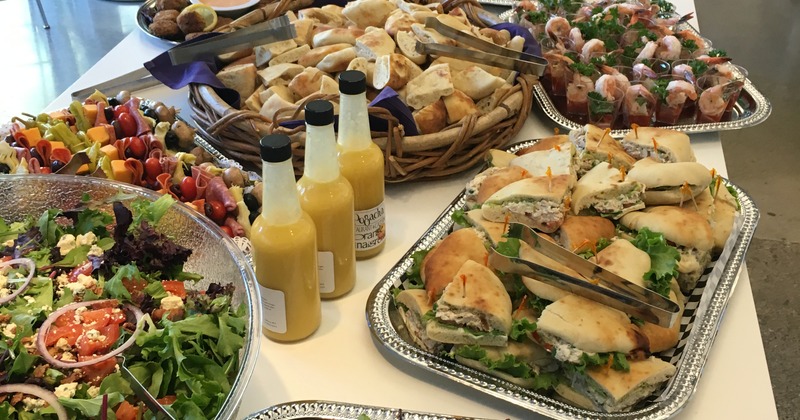 Catering trays with an abundance of food on a table