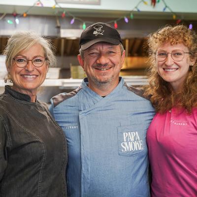The owner's family and the chef posing for a photo in the kitchen.