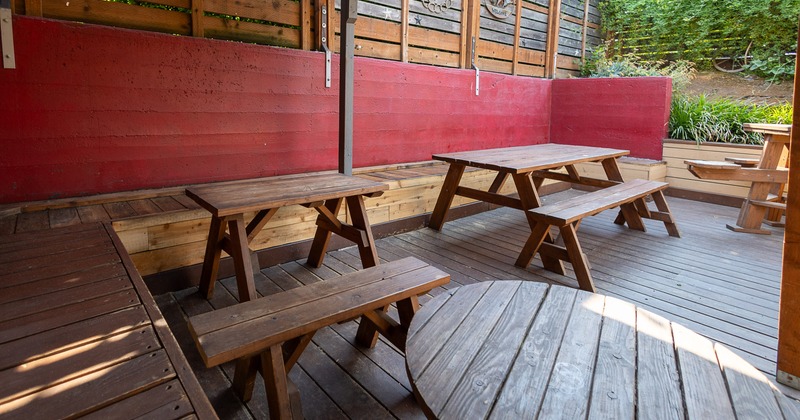 Outdoor seating area with wooden tables and benches