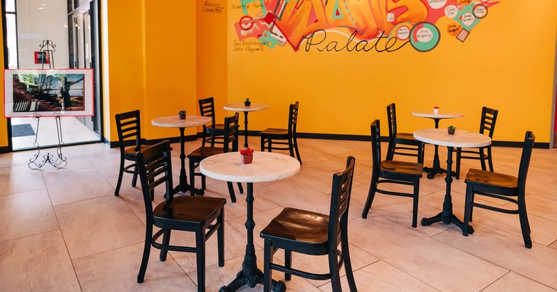 Interior, tables for two, mural art