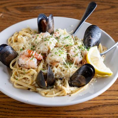 Seafood linguine served with mussels, scallops, and shrimp.