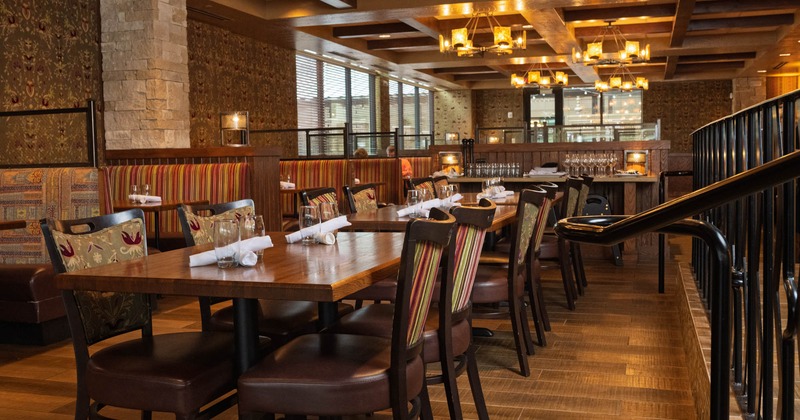 Interior, dining area, wooden top tables for four, padded seating booths, tile flooring