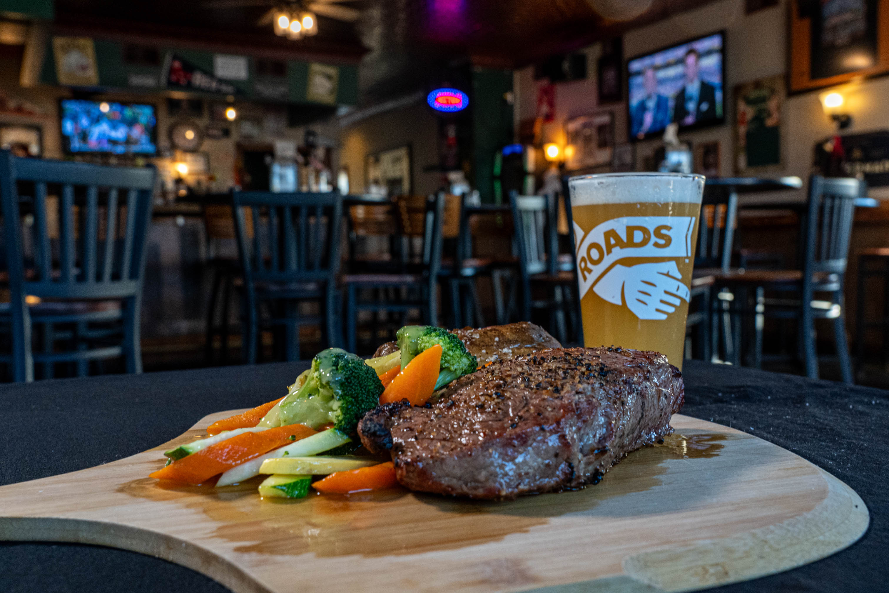 Grilled Ribeye with a side od vegetables served with a pint of beer
