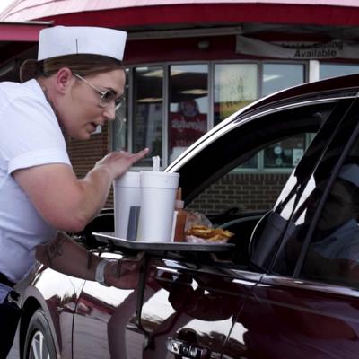 curb girl hanging tray on car.