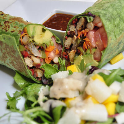 Two burritos, red dip on the side