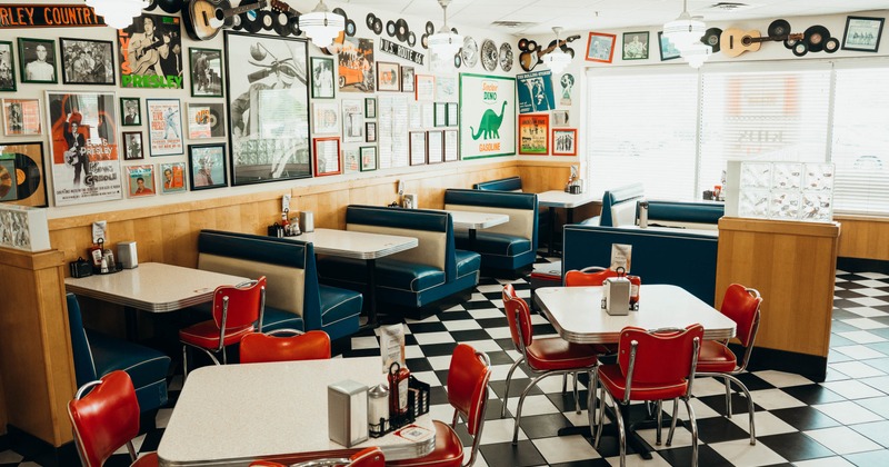 Interior, dining area with blue restaurant booths and red chairs