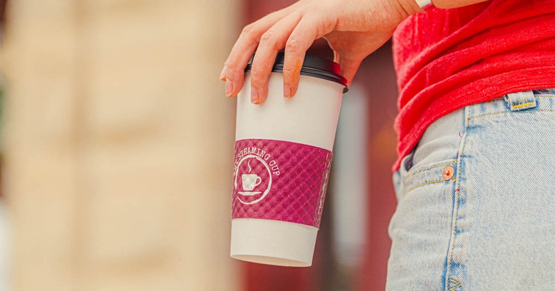 Customers holding a cup of coffee