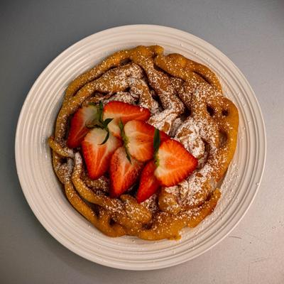Funnel cake, topped with strawberries.