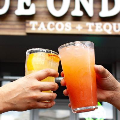 Customers toasting with cocktails.