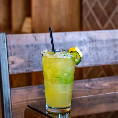 Pineapple Jalapeno Margarita garnished with  pineapple slice and jalapeno.