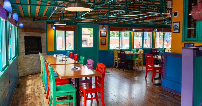 Interior, canopy room, long table setup for ten, built in fireplace, exit to the patio