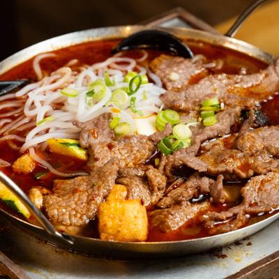 Beef noodle soup in spicy red broth.