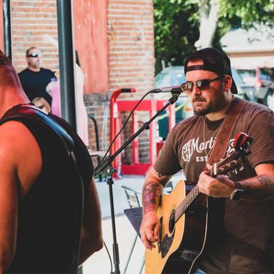 Performer playing guitar on the stage.