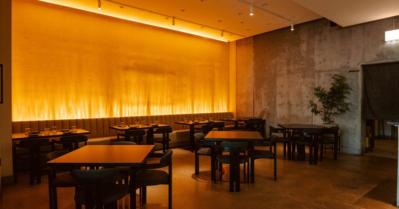 Interior seating area with warm lighting, chairs and tables