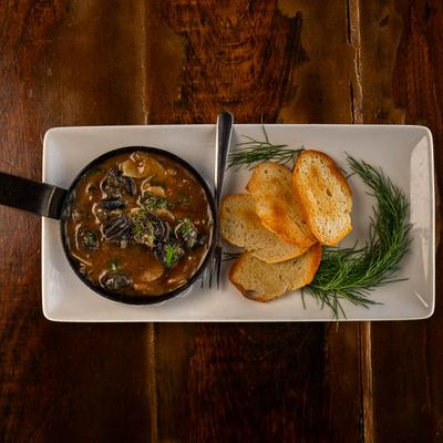 Escargot dish with toasted bread on the side, top view.