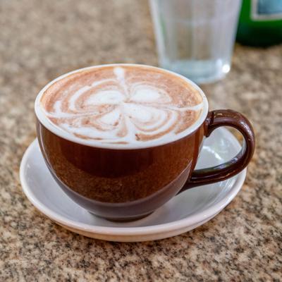 Cup of latte with flower latte design.