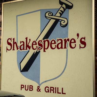 Restaurant's sign featuring a shield and a sword.