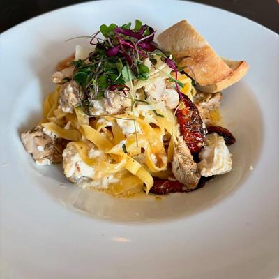 Pappardelle pasta, with mushrooms, cheese, tomatoes, herbs, and bread.