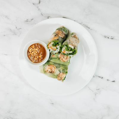 Garlic Shrimp Fresh Roll served with peanut dipping sauce on a white plate.