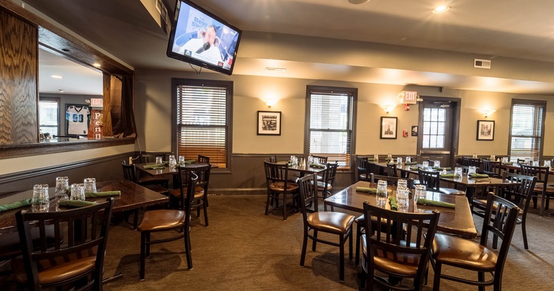 Diner area, tables and chairs, tv above