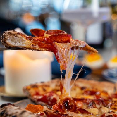 Pepperoni pizza, slice cheese pull shot.