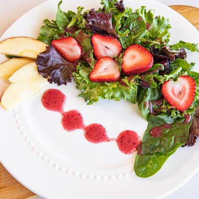 Salad with mixed greens, strawberries, and apples.