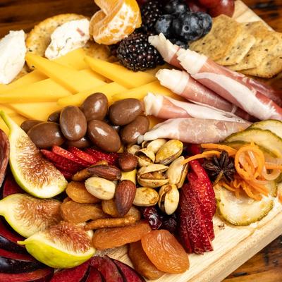Antipasto Board, artisan cheese & cured meats, local fruits, olives & house made baguette.