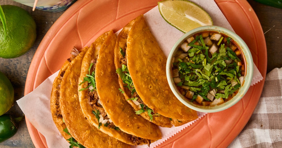 Birria tacos with dipping broth, overhead view