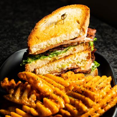 LGBTQ+ sandwich served with waffle fries.