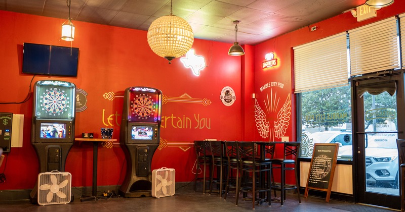 Interior, entrance, shop window, high tables with stools, electronic dart boards